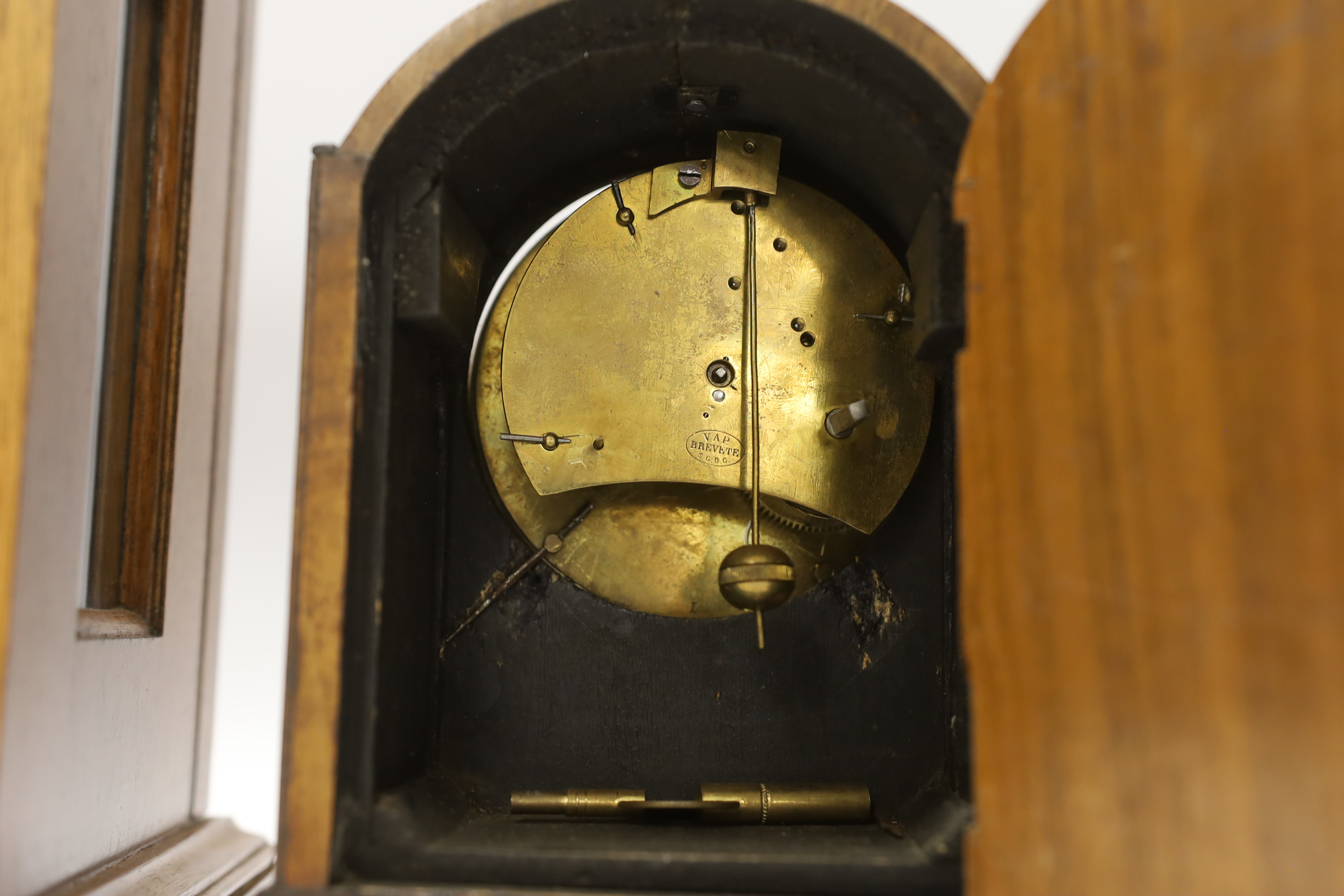 Two mantel clocks; an Elliott three train clock chiming on eight gongs, 29cm high, together with a small late 19th century timepiece by VAP Brevete